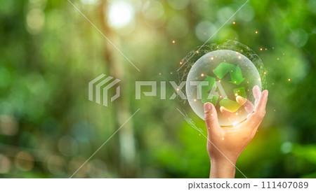 Close up of hand holding green recycle symbol. Recycle concept. 111407089