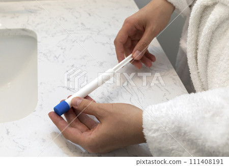 Female Hands Holding Pre-filled Applicator With Vaginal Antifungal Treatment Cream Or Gel. Caucasian Female Is Ready To Insert Tioconazole Remedy, Ointment Against Infections. Horizontal. 111408191