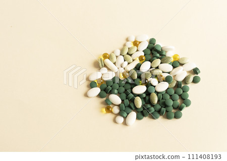Mockup Assorted Pile of Colorful Pills, Green White Yellow, Beige Tablets, Capsules, Medical Supplement on Beige Background. Copy Space For Text. Pharmaceutical Concept. Horizontal Plane Mockup Assorted Pile of Colorful Pills, Green White Yellow, Beige Tablets, Capsules, Medical Supplement on Beige Background. Copy Space For Text. Pharmaceutical Concept. Horizontal Plane 111408193