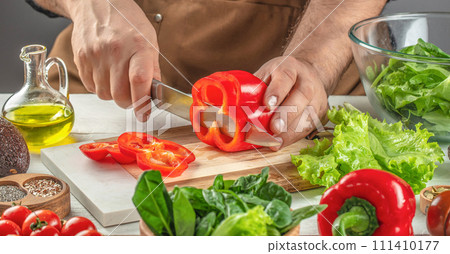 chef cooking food kitchen restaurant cutting vegetable salad. Clean eating, dieting, vegan food concept chef cooking food kitchen restaurant cutting vegetable salad. Clean eating, dieting, vegan food concept 111410177