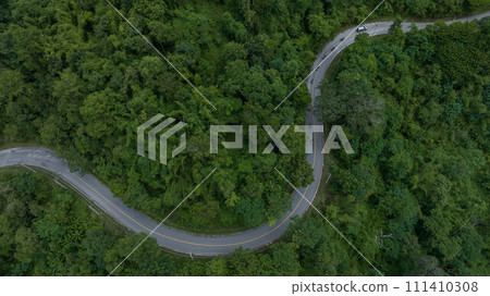 Aerial top view rural road in the green forest, Top view country road and green forest tree, Aerial view road in nature, Ecosystem and healthy environment. 111410308