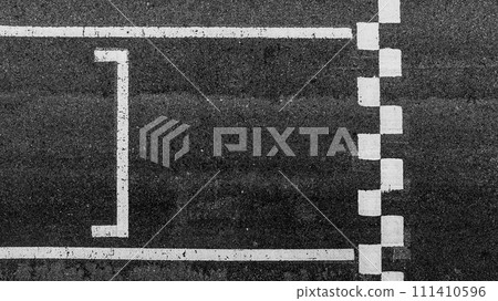 Aerial view abstract asphalt black Start and Finish grid line for race car in circuit texture background, Automobile and automotive background. Aerial view abstract asphalt black Start and Finish grid line for race car in circuit texture background, Automobile and automotive background. 111410596