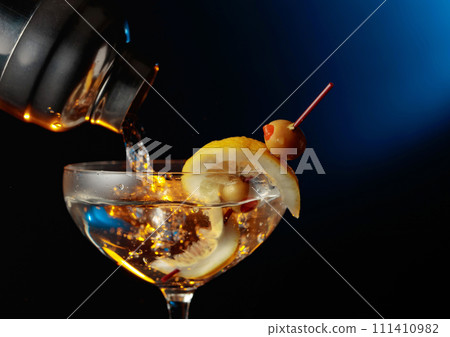 Martini with green olives and lemon. Martini with green olives and lemon. 111410982