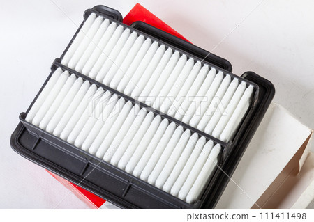 Close-up on a new car filter for an engine as a background with vertical stripes. Spare parts for vehicles, repairs and maintenance. Close-up on a new car filter for an engine as a background with vertical stripes. Spare parts for vehicles, repairs and maintenance. 111411498