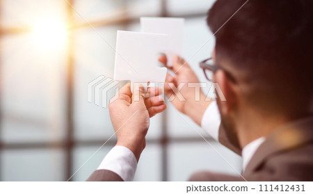 Businessman trying to connect puzzle pieces closeup Businessman trying to connect puzzle pieces closeup 111412431