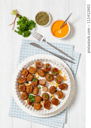 baked meatballs in white baking dish, top view 111412601