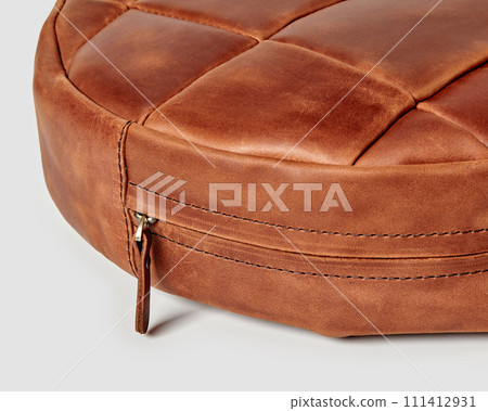 Closeup decorative round brown leather patchwork seat cushion 111412931