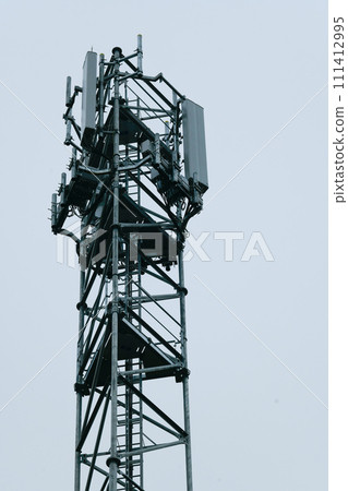 Deployment of the 5G network. Laying antennas on a mobile phone mast in the winter atmosphere Deployment of the 5G network. Laying antennas on a mobile phone mast in the winter atmosphere 111412995