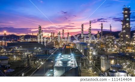 Aerial view oil and gas tank with oil refinery background at night, Glitter lighting of petrochemical plant with night, Manufacturing of petroleum, Products tank in petrochemical plant. 111414404