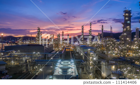 Aerial view oil and gas tank with oil refinery background at night, Glitter lighting of petrochemical plant with night, Manufacturing of petroleum, Products tank in petrochemical plant. 111414406