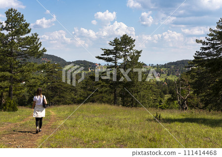 Tourist girl hiker hiking in the mountains Tourist girl hiker hiking in the mountains 111414468