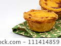 Lots of freshly baked desserts Pastel de nata or Portuguese egg tart. Pastel de Belm is a small pie with a crispy puff pastry crust and a custard cream filling. A small dessert, a cupcake 111414859
