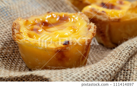 Lots of freshly baked desserts Pastel de nata or Portuguese egg tart. Pastel de Belm is a small pie with a crispy puff pastry crust and a custard cream filling. A small dessert, a cupcake 111414897