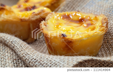 Lots of freshly baked desserts Pastel de nata or Portuguese egg tart. Pastel de Belm is a small pie with a crispy puff pastry crust and a custard cream filling. A small dessert, a cupcake 111414904