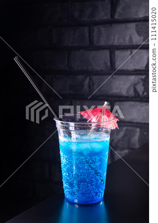 Blue lemonade with ice cubes in a plastic glass Blue lemonade with ice cubes in a plastic glass 111415020