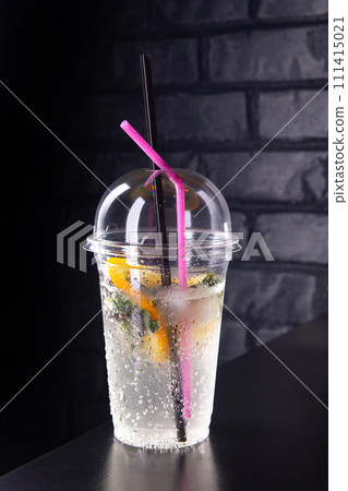 Lemonade with lemon slices in a plastic glass Lemonade with lemon slices in a plastic glass 111415021