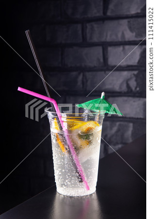 Lemonade with lemon slices in a plastic glass 111415022