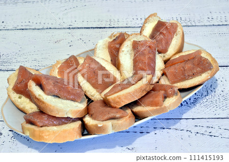 Canapes with red fish on a plate. Canapes with red fish on a plate. 111415193