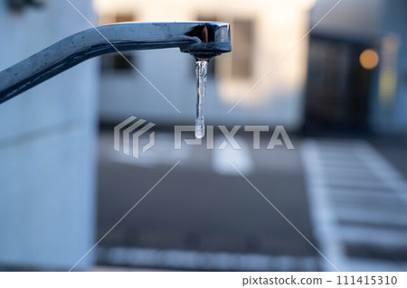 Icicles dripping from the water tap Icicles dripping from the water tap 111415310