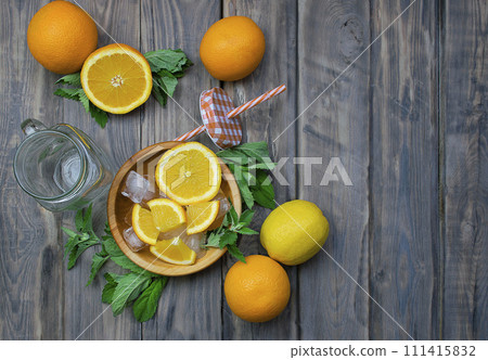 composition with fresh orange , mint, lemons closeup. Fresh natural drink and fruits. composition with fresh orange , mint, lemons closeup. Fresh natural drink and fruits. 111415832