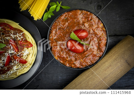 Tomato sauce and Italian spaghetti  with parmesan cheese and basil served on the plate 111415968