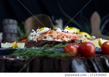 Salted salmon open sandwich with eggs, tomatoes, olives, cream cheese, cucumber and garlick. Healthy seafood Salted salmon open sandwich with eggs, tomatoes, olives, cream cheese, cucumber and garlick. Healthy seafood 111416004