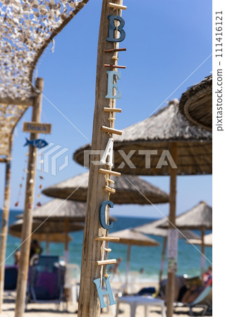 Beach sign. Wooden letters hanging from a post 111416121