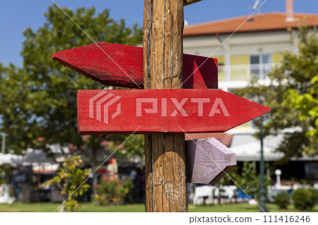 Wooden arrow sign post. Empty boards for your text Wooden arrow sign post. Empty boards for your text 111416246