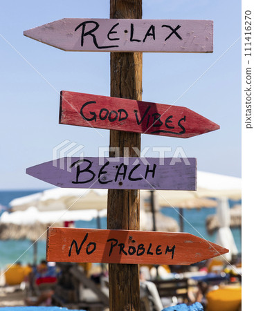 Wooden arrow sign post at the beach Wooden arrow sign post at the beach 111416270