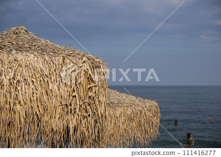 Umbrella made from palm tree leaves at the beach 111416277