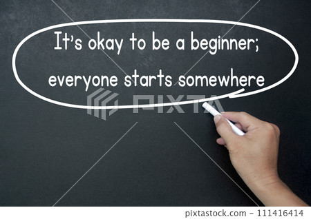 Hand writing It is okay to be a beginner affirmation on black board. Affirmation concept. Hand writing It is okay to be a beginner affirmation on black board. Affirmation concept. 111416414