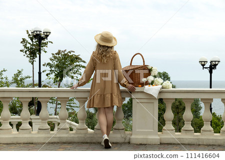 Beautiful girl with flowers on the street in summer. Beautiful girl with flowers on the street in summer. 111416604