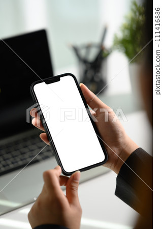 Closeup businesswoman using smartphone at office desk. Blank screen for advertising Closeup businesswoman using smartphone at office desk. Blank screen for advertising 111416886