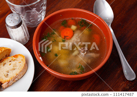 Light vegetable soup with slices of pork Light vegetable soup with slices of pork 111417487