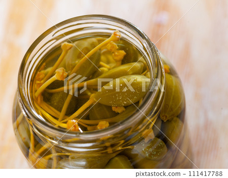 Glass jar with pickled green capers 111417788
