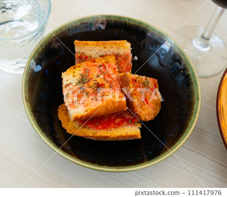Kitchen table with cooking tools and fresh vegetables. Pan Con tomate, bread with tomato and garlic. Catalonian cuisine. Spain 111417976