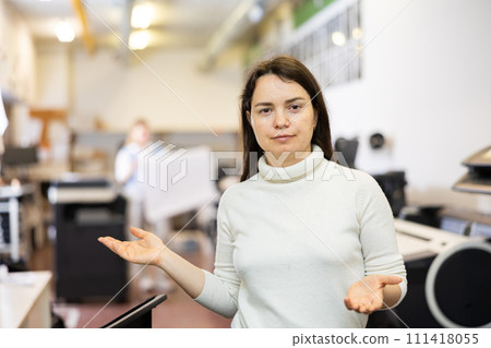 Cheerful woman publishing facility worker gesturing and smiling 111418055
