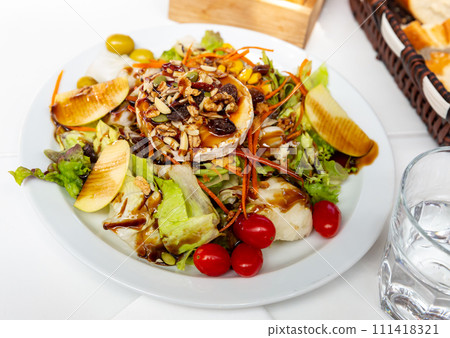 Tasty salad with goat cheese, nuts and apples. Spanish cuisine 111418321