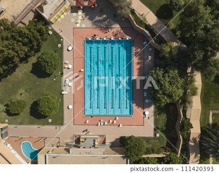 An Aerial View of a Swimming Pool Amidst Lush Greenery An Aerial View of a Swimming Pool Amidst Lush Greenery 111420393