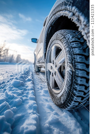 Close-up image of a car tires on the road in winter. Close-up image of a car tires on the road in winter. 111421335