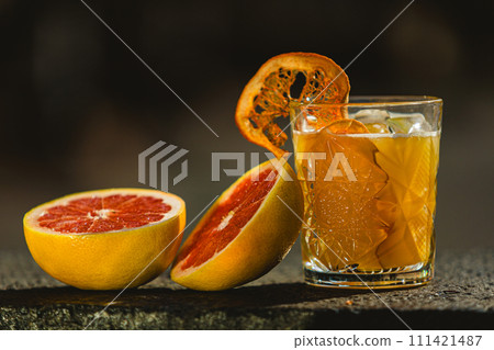 Delicious old fashion cocktail in the etched glass with ice and orange slices. Shallow dof. Delicious old fashion cocktail in the etched glass with ice and orange slices. Shallow dof. 111421487
