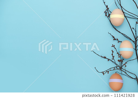 Decorated eggs on a branch. Fun empty Easter background Decorated eggs on a branch. Fun empty Easter background 111421928