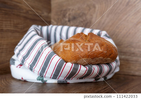 Loaf of freshly baked bread in cotton textile bag Loaf of freshly baked bread in cotton textile bag 111422033