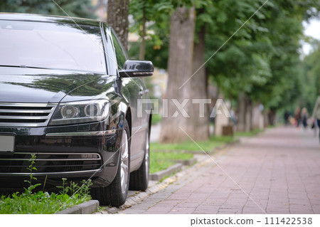 Close up of a car parked on city street side. Urban traffic concept Close up of a car parked on city street side. Urban traffic concept 111422538