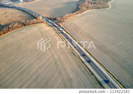 Aerial view of intercity road with fast driving cars at sunset. Top view from drone of highway traffic in evening 111422581