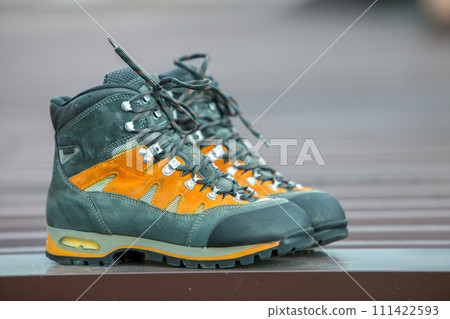 A pair of leather trekking hiking winter boots on blurred background A pair of leather trekking hiking winter boots on blurred background 111422593