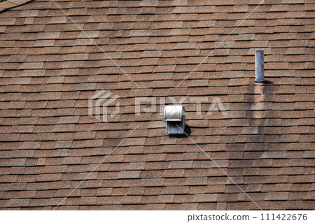 Closeup of house roof top covered with asphalt or bitumen shingles. Waterproofing of new building 111422676