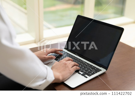 Hands typing on a laptop 111422702
