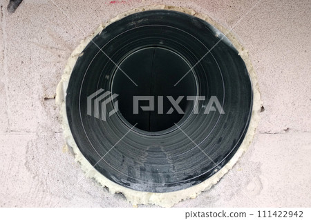 Metal ventilation pipe integrated in whine block wall under construction. Metal ventilation pipe integrated in whine block wall under construction. 111422942