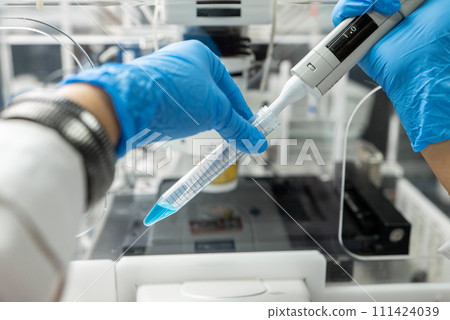 Dripping liquid from pipette into test tube in laboratory, closeup Dripping liquid from pipette into test tube in laboratory, closeup 111424039